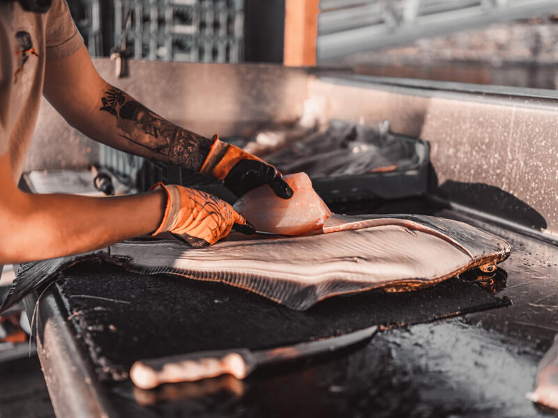 Deckhand processing a Salmon in the Marina