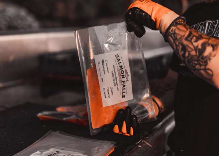 Deckhand packaging a Salmon Filet for Freezing