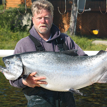 Captain Gary Souza holding a King Salmon
