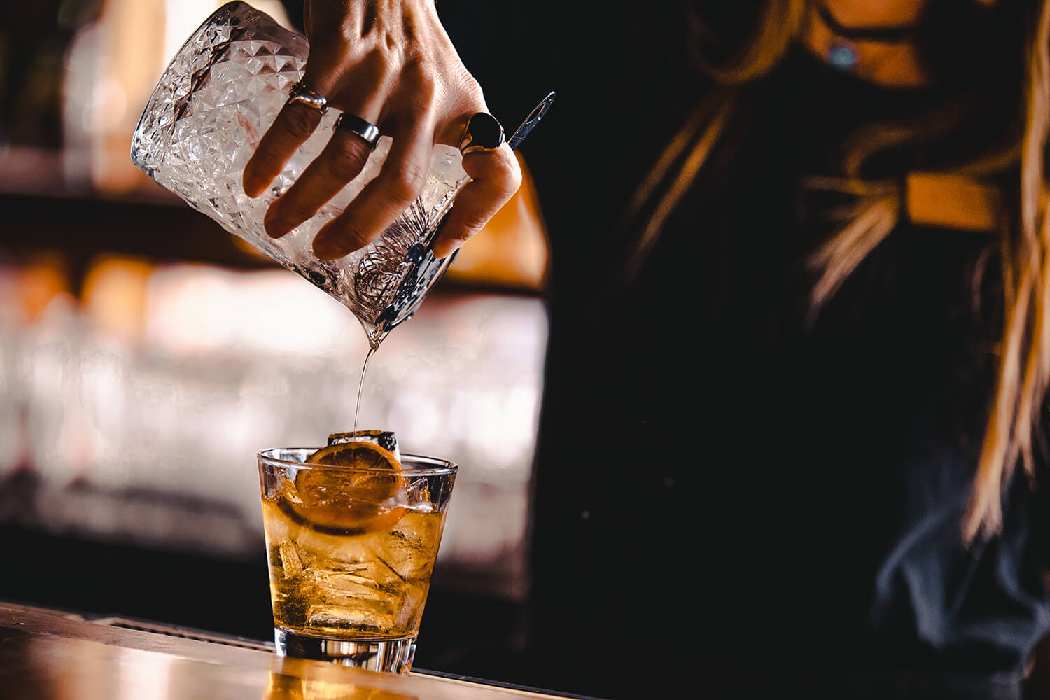 Pouring a drink at the bar at Timbers Restaurant